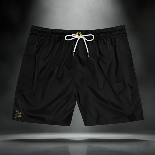 black swim trunks with white drawstring, gold 3 + 3 = 6 hands, and gold Sixth Stitch signature on right leg.