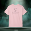 Back view of the First Impression Tee in blossom pink showing the large “S” script logo above the text “SIXTH STITCH – NEXT LEVEL APPAREL.”