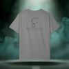 Back view of the First Impression Tee in granite grey showing the large “S” script logo above the text “SIXTH STITCH – NEXT LEVEL APPAREL.”
