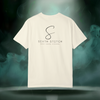 Back view of the First Impression Tee in ivory showing the large “S” script logo above the text “SIXTH STITCH – NEXT LEVEL APPAREL.”