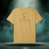 Back view of the First Impression Tee in mustard yellow showing the large “S” script logo above the text “SIXTH STITCH – NEXT LEVEL APPAREL.”