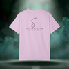 Back view of the First Impression Tee in orchid pink showing the large “S” script logo above the text “SIXTH STITCH – NEXT LEVEL APPAREL.”