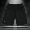 Golden Cipher Shorts front view — black jogger-style shorts featuring gold “SS” Sixth Stitch acronym embroidery on the left leg, luxury streetwear design with minimalist appeal.