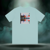 Back of Sixth Stitch Lucid Blur Tee in heather ice blue featuring surreal “Lucid Blur” city reflection graphic with neon hues, blurred lighting, and mirrored Sixth Stitch text.