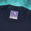 Front of Sixth Stitch Lucid Blur Tee in navy blue featuring minimalist collar tag logo with a balloon drifting to another realm.