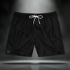 black swim trunks with white drawstring, gold 3 + 3 = 6 hands, and gold Sixth Stitch signature on right leg.