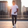 White Noise Polo in white stitch — sleek white performance polo shirt modeled in daylight city rooftop scene, minimal streetwear design by Sixth Stitch, elevated casual fit with embroidered logo.